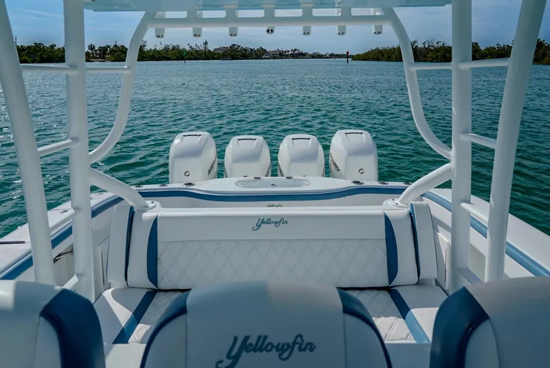 Slide: The Image of 2023 Yellowfin 42 boat with triple engines on calm water. - 9