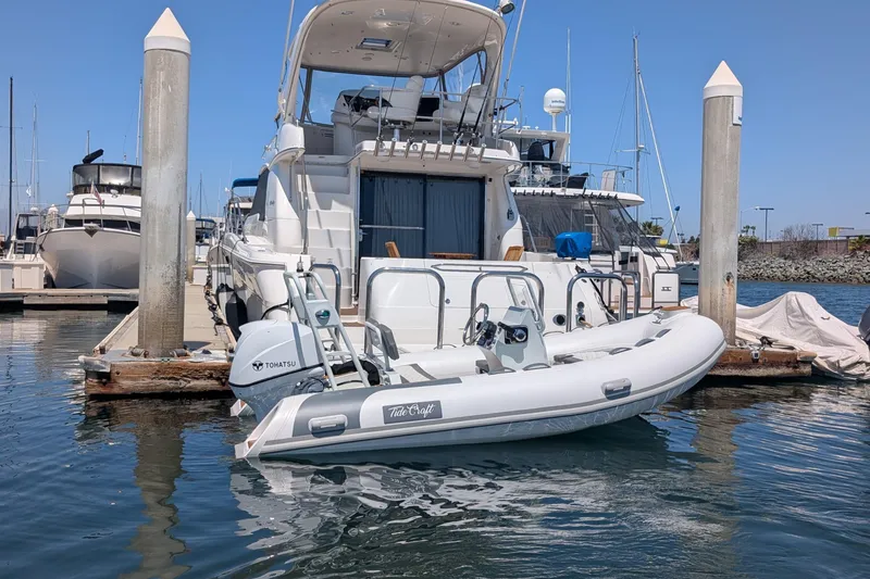 Slide: The Image of Tide Craft Nantucket 12 boat docked at marina, featuring Tohatsu engine, 2026 model. - 11