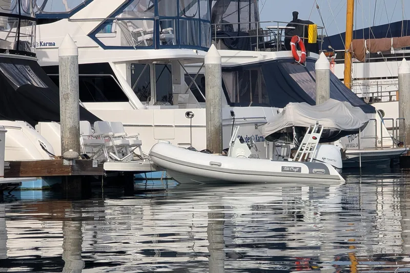 Slide: The Image of Docked Tide Craft Nantucket 12 boat, 2025 model, at a marina with yachts. - 4