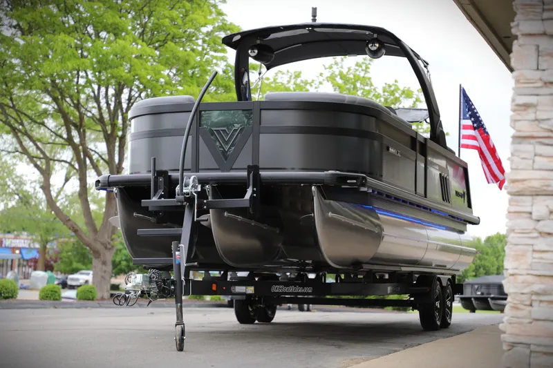 Slide: The Image of 2025 Viaggio Diamante UWA pontoon boat on trailer, American flag, outdoor setting. - 10