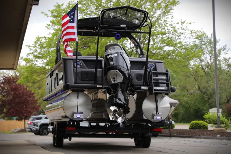 Slide: The Image of 2025 Viaggio Diamante UWA pontoon boat with American flag and powerful outboard motor. - 8