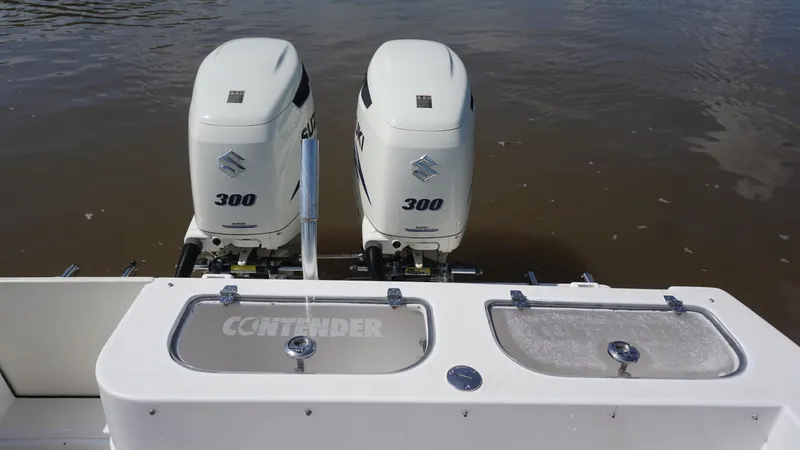 Slide: The Image of 2003 Contender 31 Open boat with dual Suzuki 300 outboard engines on water. - 10