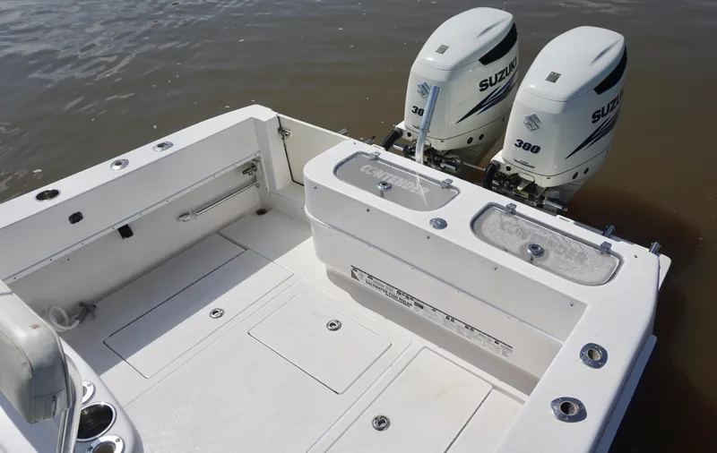 Slide: The Image of 2003 Contender 31 Open boat with dual Suzuki 300 engines, spacious deck, and fishing amenities. - 11