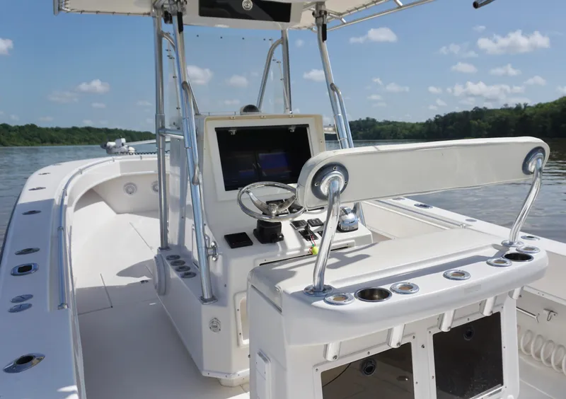 Slide: The Image of 2003 Contender 31 Open boat interior with steering console on a sunny day. - 12