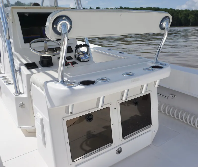 Slide: The Image of 2003 Contender 31 Open boat console with steering wheel and rod holders. - 13