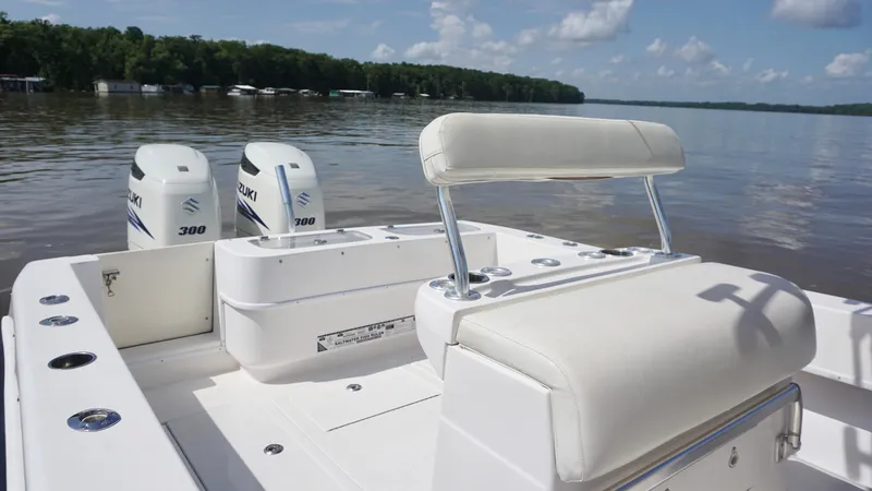Slide: The Image of 2003 Contender 31 Open boat with dual Suzuki 300 engines on a calm lake. - 14