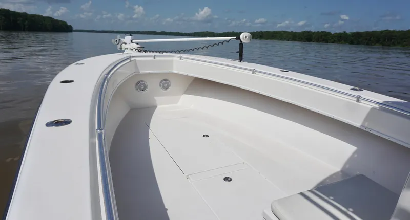 Slide: The Image of 2003 Contender 31 Open boat on calm water, showcasing spacious deck and sleek design. - 17