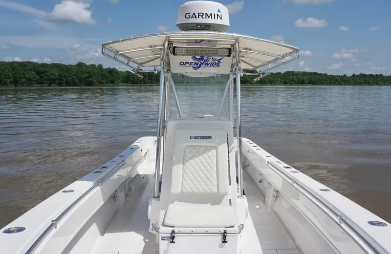 Slide: The Image of 2003 Contender 31 Open boat on calm water, featuring Garmin equipment and clear skies. - 19