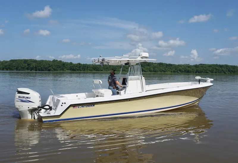 Slide: The Image of 2003 Contender 31 Open boat on calm water with Suzuki outboard motor. - 3