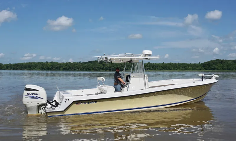 Slide: The Image of 2003 Contender 31 Open boat on calm water, featuring Suzuki outboard motor. - 4