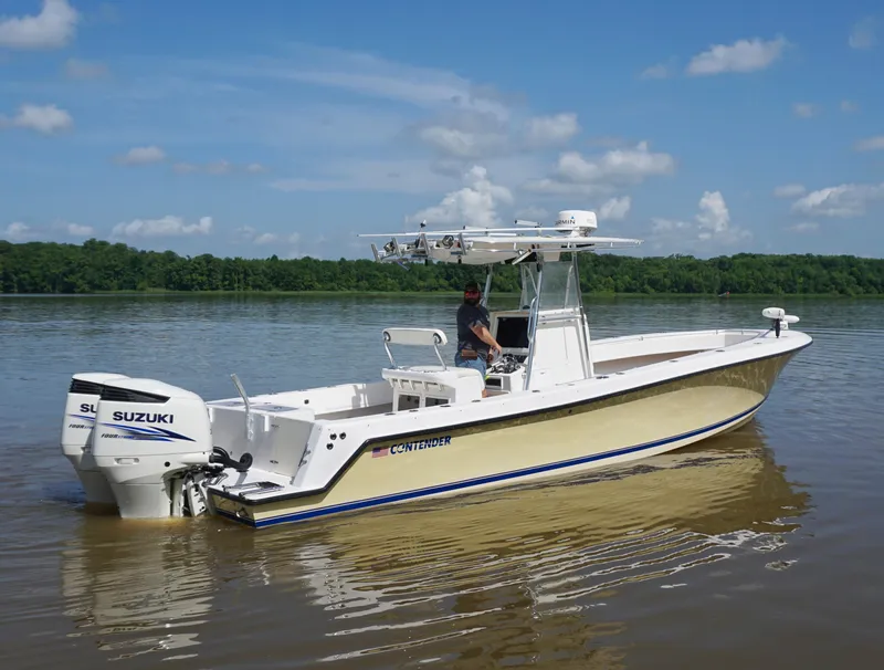 Slide: The Image of 2003 Contender 31 Open boat on calm water with Suzuki engines. - 5