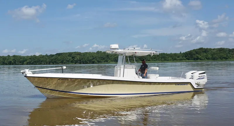 Slide: The Image of 2003 Contender 31 Open boat on calm water with a person at the helm. - 6