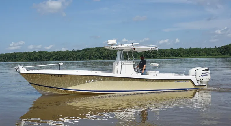 Slide: The Image of 2003 Contender 31 Open boat on calm water with Suzuki engines. - 7