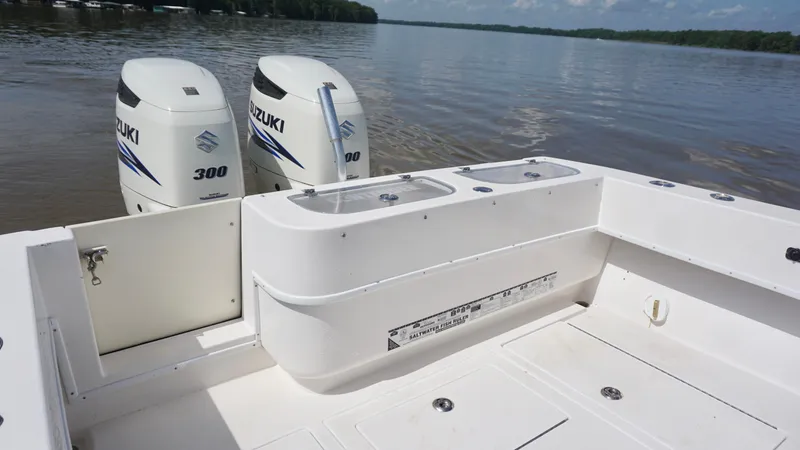 Slide: The Image of 2003 Contender 31 Open boat with dual Suzuki 300 engines on a calm lake. - 8