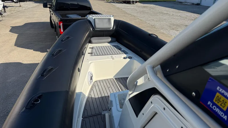 Slide: The Image of 2022 Brig Eagle 8 boat interior with black inflatable sides and gray flooring. - 11