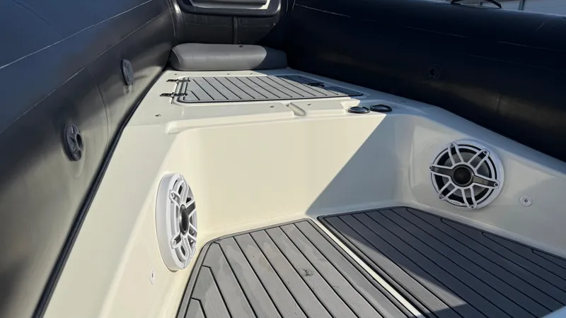 Slide: The Image of 2022 Brig Eagle 8 boat interior with speakers and seating area. - 13