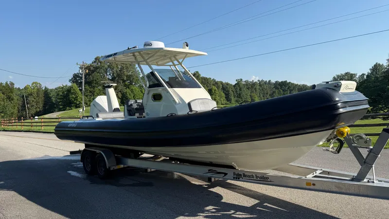 Slide: The Image of 2022 Brig Eagle 8 boat on trailer, parked on a sunny road. - 4