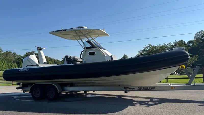 Slide: The Image of 2022 Brig Eagle 8 boat on trailer, parked outdoors under clear blue sky. - 5