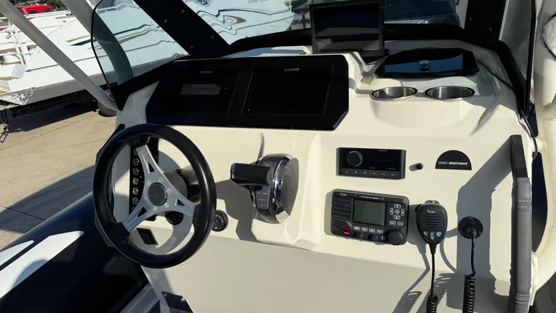 Slide: The Image of 2022 Brig Eagle 8 boat dashboard with steering wheel and navigation controls. - 8