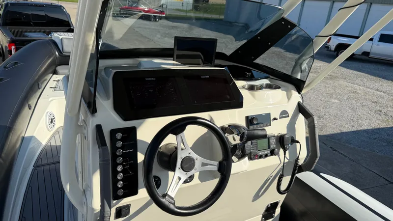 Slide: The Image of 2022 Brig Eagle 8 boat dashboard with steering wheel and navigation controls. - 9