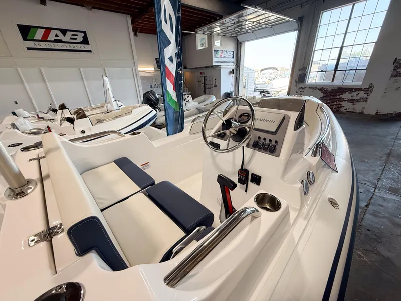 Slide: The Image of 2024 AB Inflatables Nautilus 15 DLX boat interior with steering wheel and seating. - 14