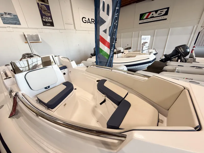 Slide: The Image of 2024 AB Inflatables Nautilus 15 DLX boat interior with seating and console in showroom. - 15