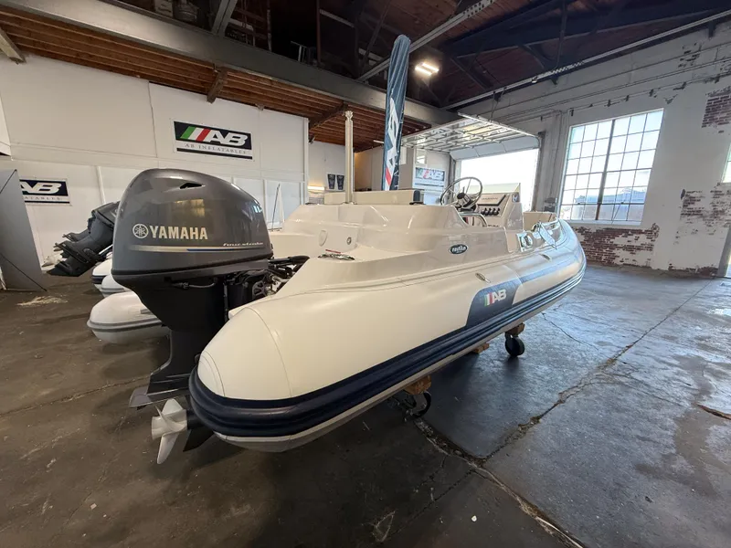 Slide: The Image of 2024 AB Inflatables Nautilus 15 DLX boat with Yamaha engine in a showroom. - 16