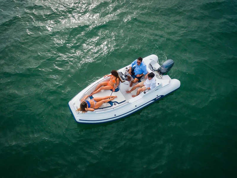 Slide: The Image of 2024 AB Inflatables Nautilus 15 DLX boat cruising with passengers on open water. - 18