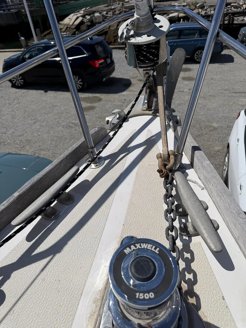 Slide: The Image of Bow of 1982 Tartan 37 sailboat with Maxwell 1500 windlass, parked cars in background. - 15