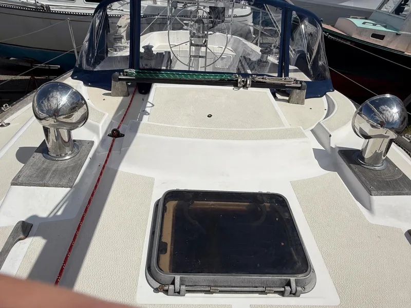 Slide: The Image of Deck view of a 1982 Tartan 37 sailboat, featuring a hatch and polished fittings. - 20