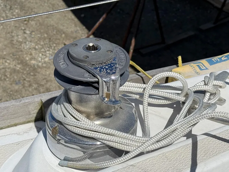 Slide: The Image of Winch on 1982 Tartan 37 sailboat with coiled rope, in sunlight. - 27