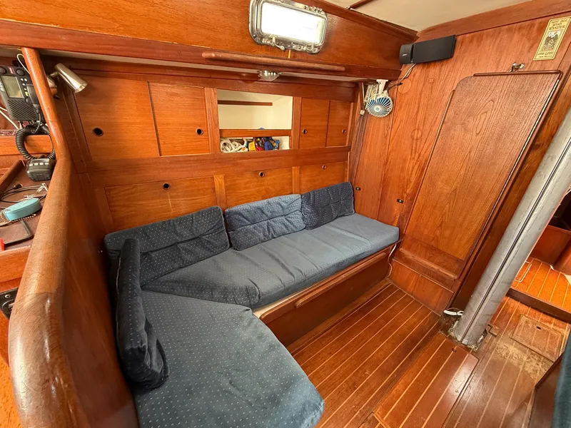 Slide: The Image of Cozy interior of 1982 Tartan 37 sailboat with wooden paneling and blue cushions. - 33
