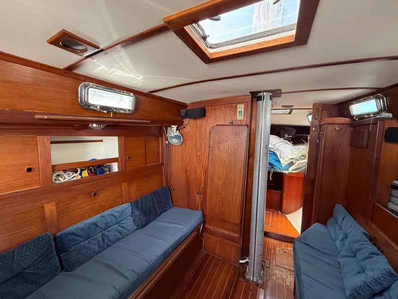 Slide: The Image of Interior of 1982 Tartan 37 sailboat with wooden finish and blue cushions. - 34