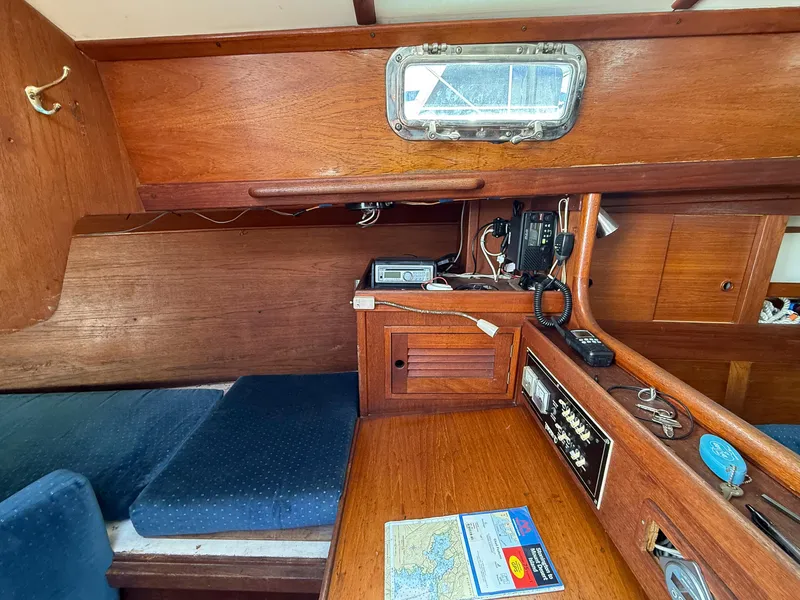Slide: The Image of Interior of a 1982 Tartan 37 sailboat with navigation equipment and wooden cabinetry. - 37
