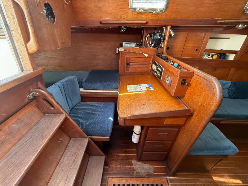 Slide: The Image of Interior of 1982 Tartan 37 sailboat with wooden navigation desk and seating area. - 38