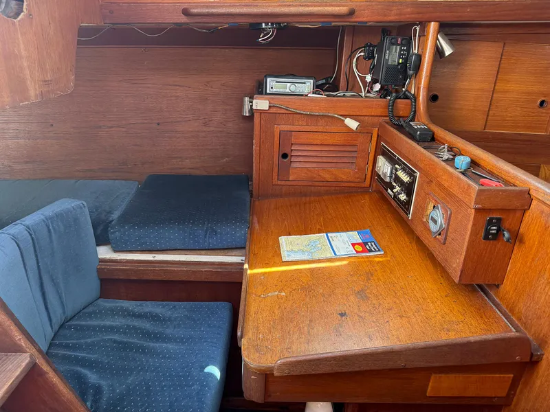 Slide: The Image of 1982 Tartan 37 sailboat interior with navigation station and blue cushions. - 39