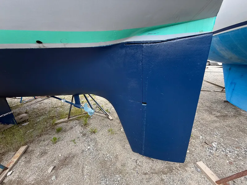 Slide: The Image of 1982 Tartan 37 sailboat keel and rudder on dry dock. - 4