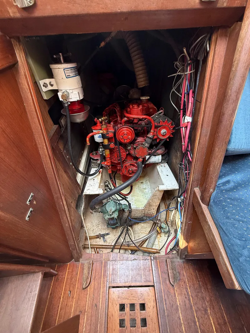 Slide: The Image of Engine compartment of a 1982 Tartan 37 sailboat, featuring a red engine and wiring. - 40