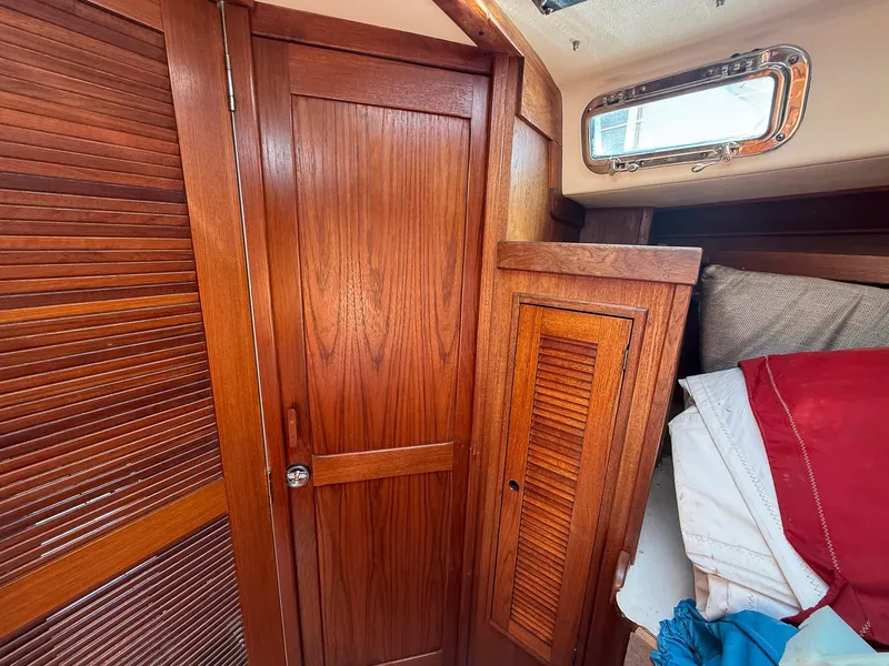 Slide: The Image of Interior of 1982 Tartan 37 sailboat with wooden cabinetry and porthole window. - 41