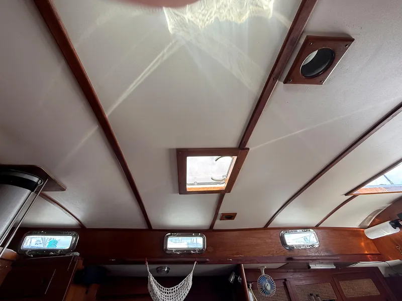 Slide: The Image of Interior ceiling of a 1982 Tartan 37 sailboat with wooden accents and portholes. - 44