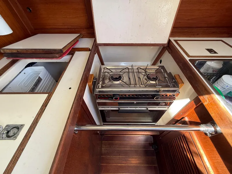 Slide: The Image of Compact kitchen area in a 1982 Tartan 37 sailboat with a two-burner stove. - 48