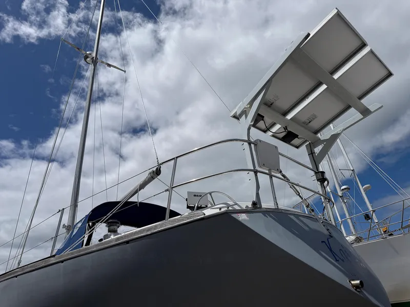 Slide: The Image of 1982 Tartan 37 sailboat with solar panels under a cloudy sky. - 9