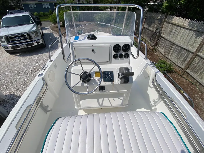 Slide: The Image of 1995 Edgewater Dougherty 1800 CC Marlin boat interior with steering wheel and controls. - 12