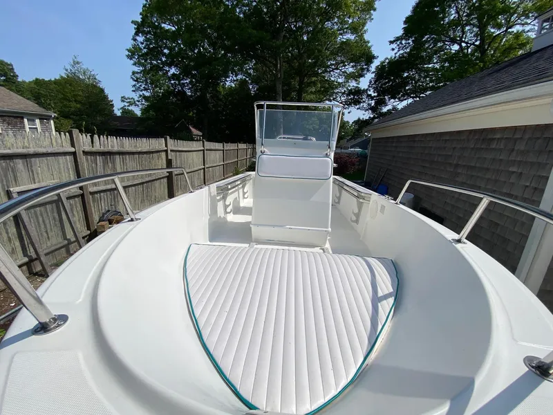 Slide: The Image of 1995 Edgewater Dougherty 1800 CC Marlin boat with white deck and railing, parked outdoors. - 14