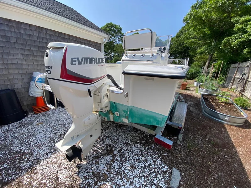 Slide: The Image of 1995 Edgewater Dougherty 1800 CC Marlin boat with Evinrude motor in a garden setting. - 7