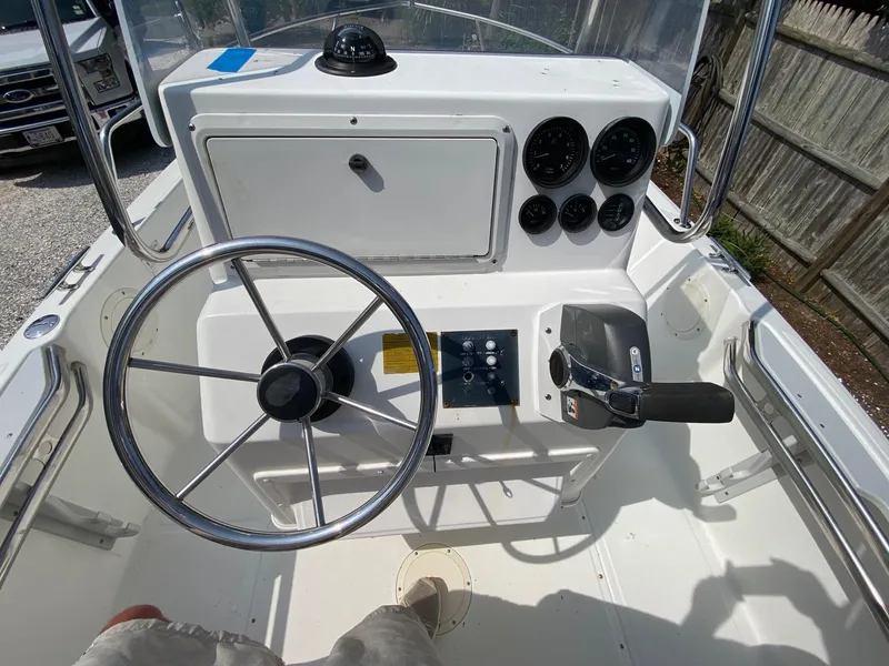 Slide: The Image of Steering console of a 1995 Edgewater Dougherty 1800 CC Marlin boat with gauges and controls. - 8
