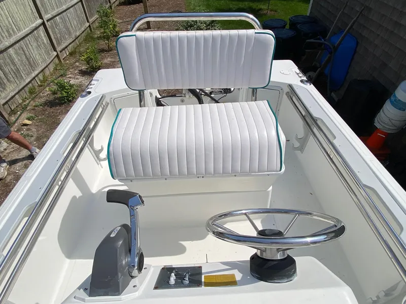 Slide: The Image of 1995 Edgewater Dougherty 1800 CC Marlin boat interior with steering wheel and seating. - 9