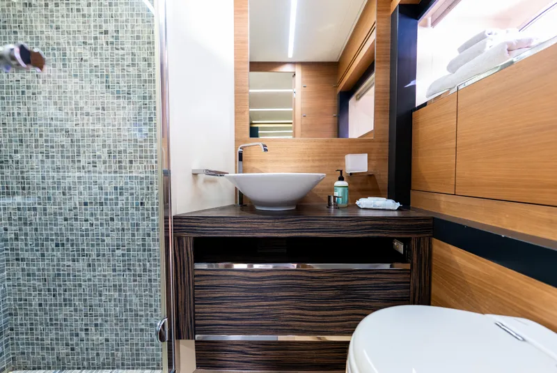 Slide: The Image of Luxurious bathroom in 2012 Pershing 92 yacht with modern sink and mosaic-tiled shower. - 17