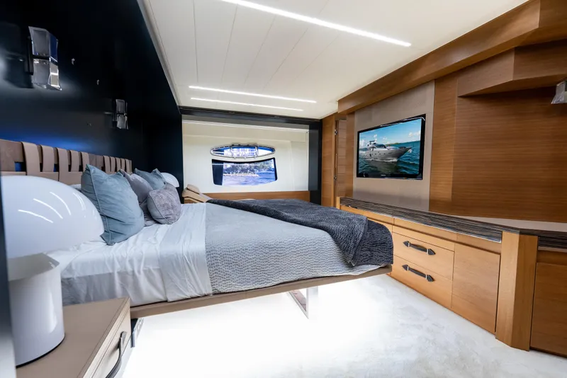 Slide: The Image of Luxurious bedroom interior on a 2012 Pershing 92 yacht, featuring modern design and elegant furnishings. - 21