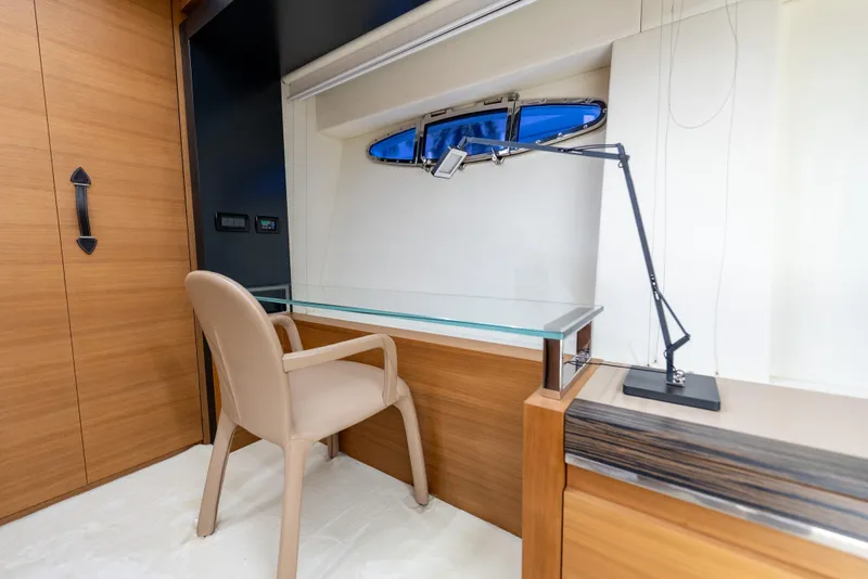 Slide: The Image of Luxurious interior of 2012 Pershing 92 yacht with modern desk and chair setup. - 22